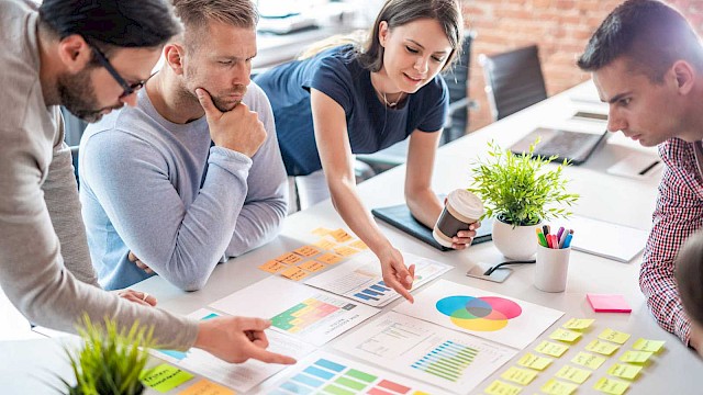 Group of people considering colours for marketing