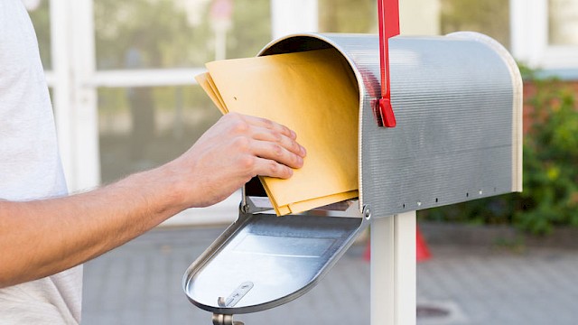 letters being taken out of mailbox